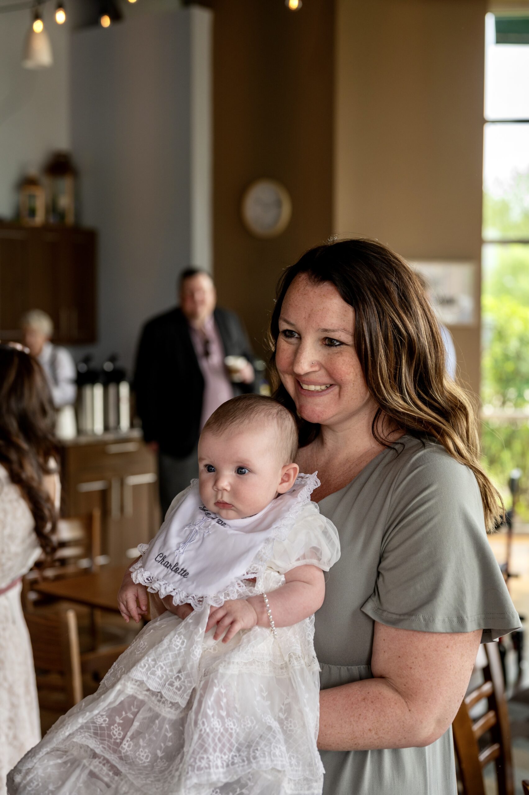 Mom at church with baby on baptism day